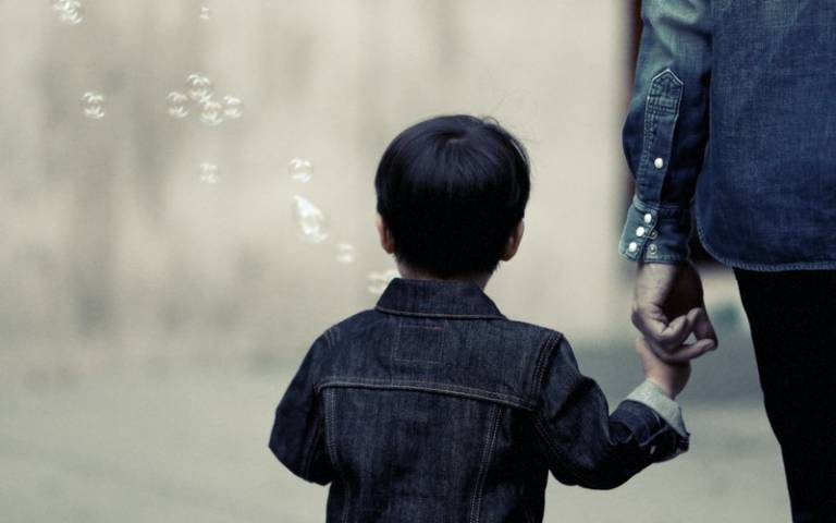 Child walking with their parent. Image: Life of Pix via Pexels
