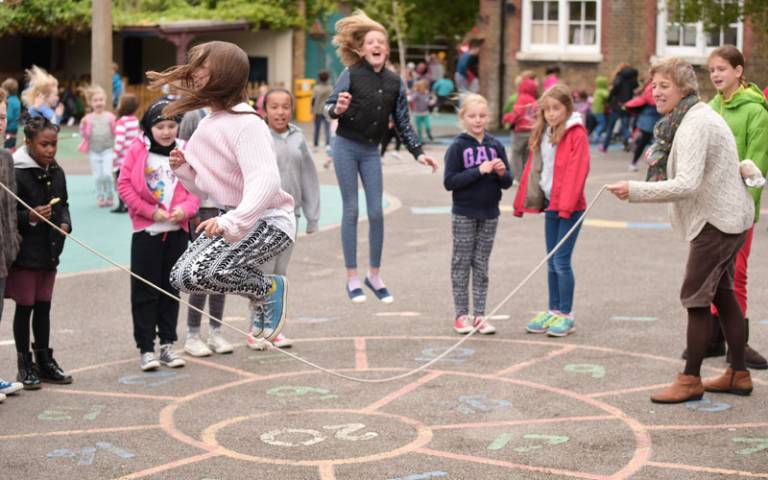 Children skipping in the school playground