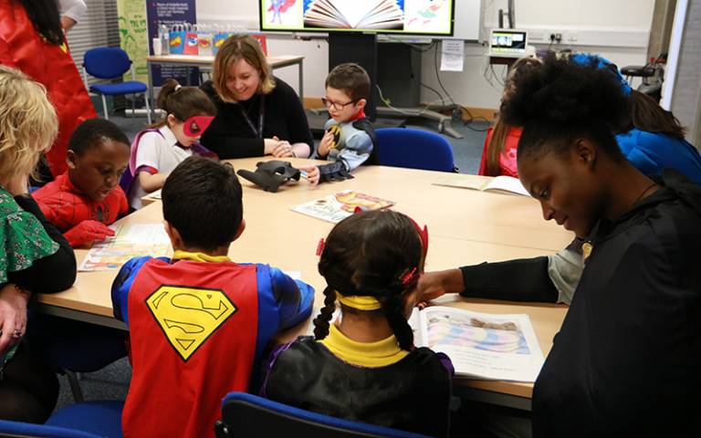 Teachers and children reading at table in class. Image: Sarah-Jane Gregori for UCL Institute of Education