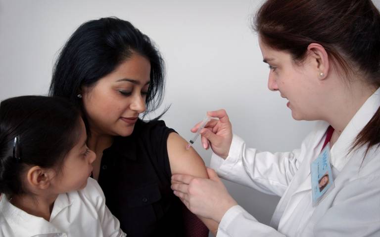 Doctor injecting patient with vaccine. Image: CDC via Unsplash