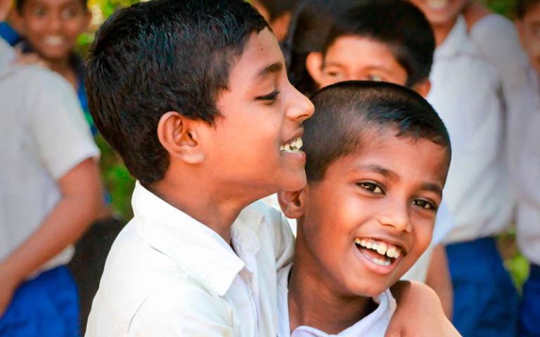 Two students hugging. Credit: Darshina Witharana via Shutterstock.
