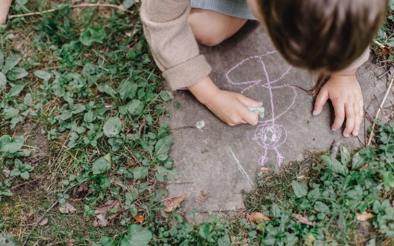 Child drawing on the floor in crayon. Image: Allan Mas via Pexels