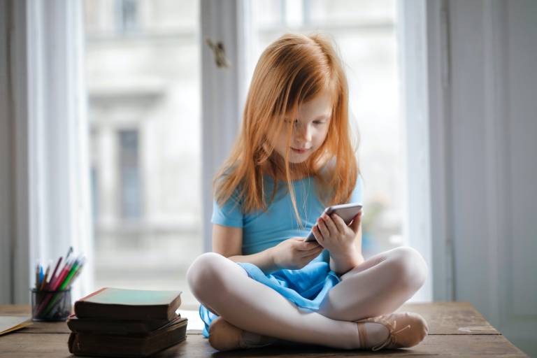 Child reading on phone. Image: Andrea Piacquadio from Pexels