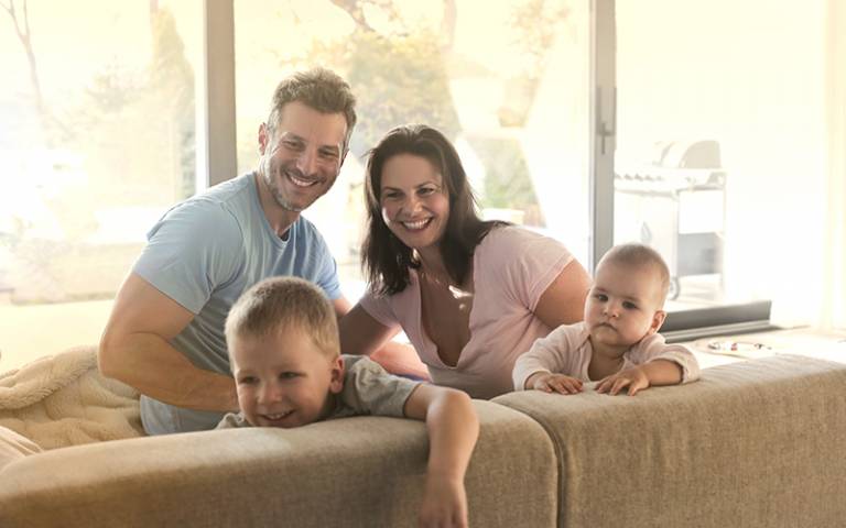 Couple with children at home. Image by olly / Adobe Stock.