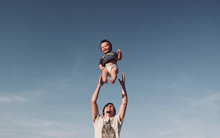 Father raising son in the air outside. Image: Dominika Roseclay via Pexels