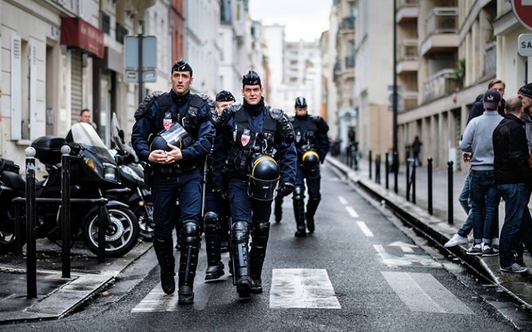 French anti-riot police walk down a Paris street. Credit: Kristoffer Trolle, via Flickr (CC BY 2.0)