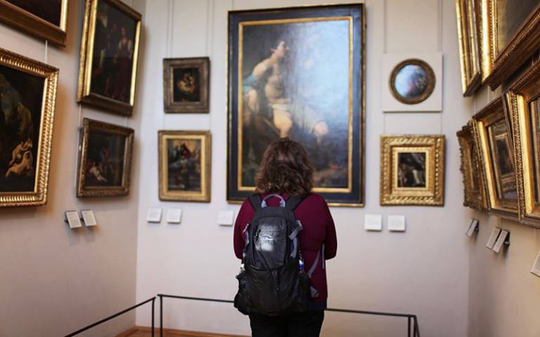 Girl staring at art in a museum