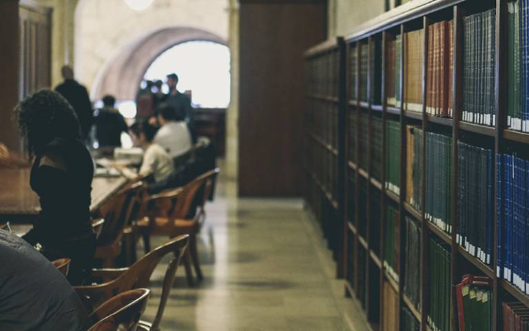 Library with books and students. Image: Davide Cantelli on Unsplash