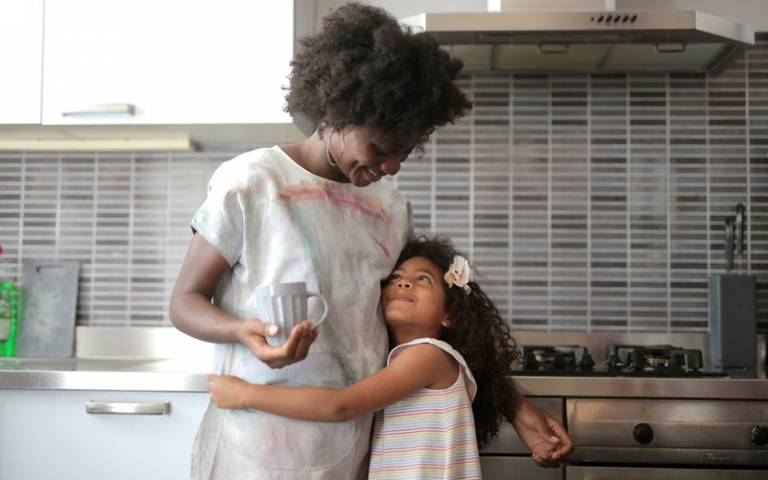 Mother and daughter standing together in the kitchen. Image: Andrea Piacquadio via Pexels