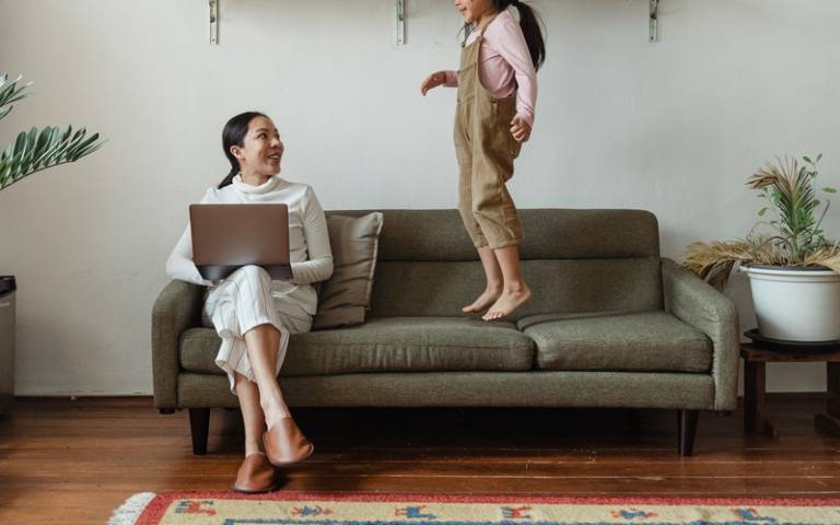 Mother sitting and daughter jumping on sofa next to her. Image: Ketut Subiyanto from Pexels