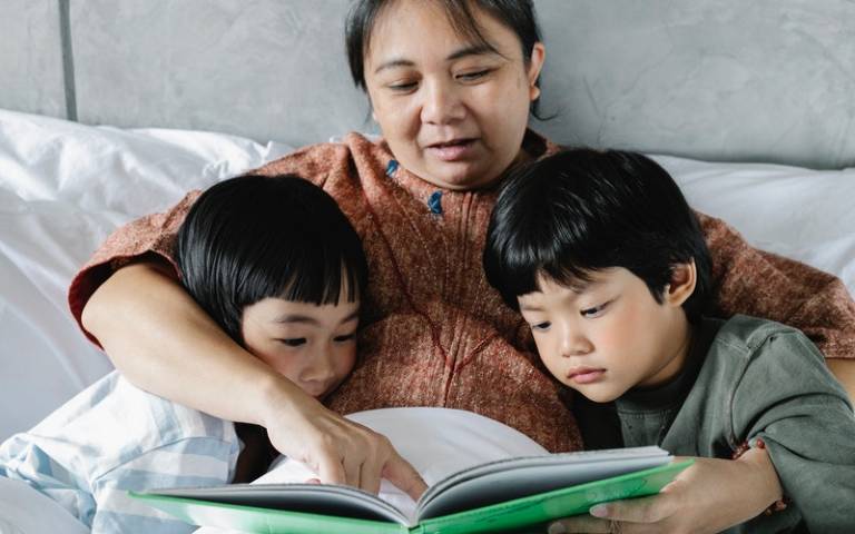 A mother reading with her two children. Image: Alex Green via Pexels