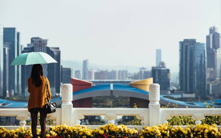 Person looking at city in Shenzhen, China. Image: Robert Bye via Unsplash
