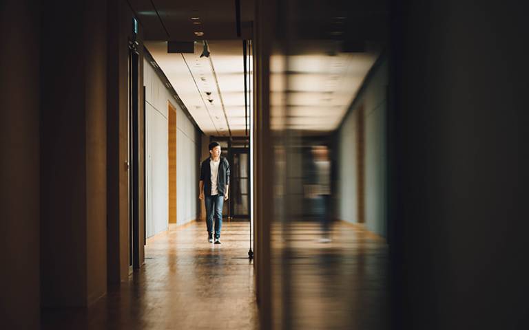Person walking through building. Image: CHUTTERSNAP via Unsplash