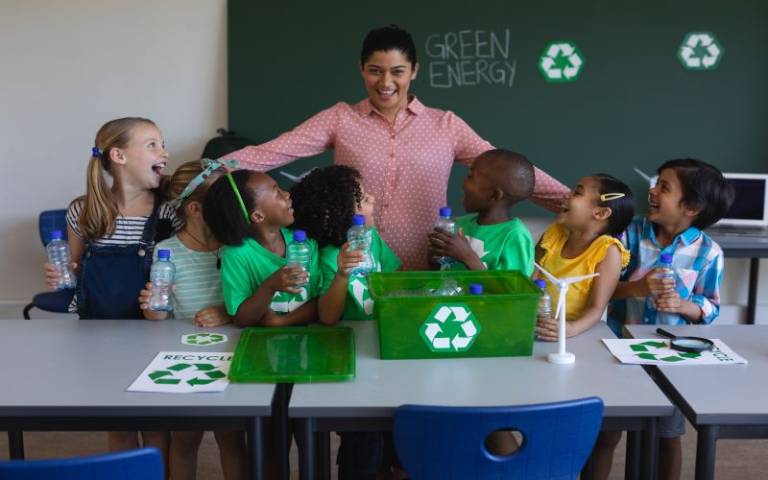 Students and a teacher learning about sustainability. Image credit: wavebreak3 via Adobe Stock.