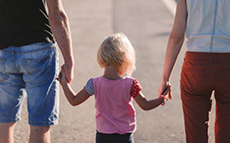 Girl holding parents hands. Photo by freestocks.org from Pexels
