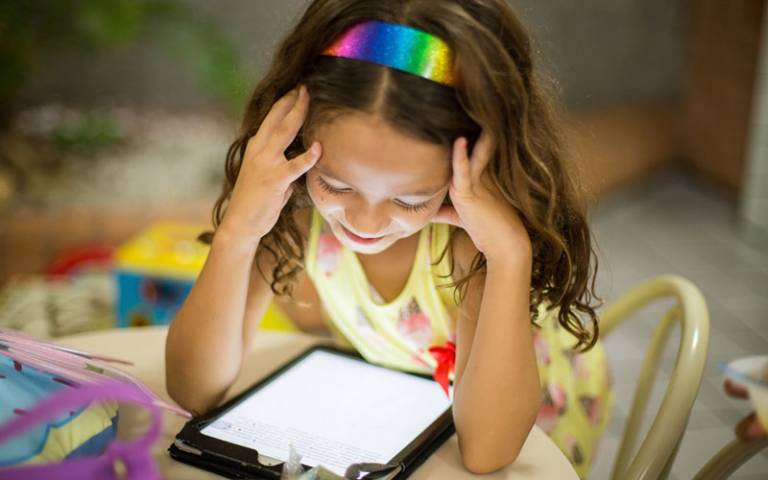Girl reading from a tablet