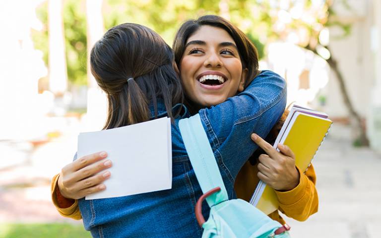 Two girls embrace after receiving their exam results. (Photo: AntonioDiaz / Adobe Stock)
