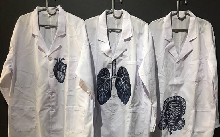 Lab coats printed with a heart, lungs, and intestines