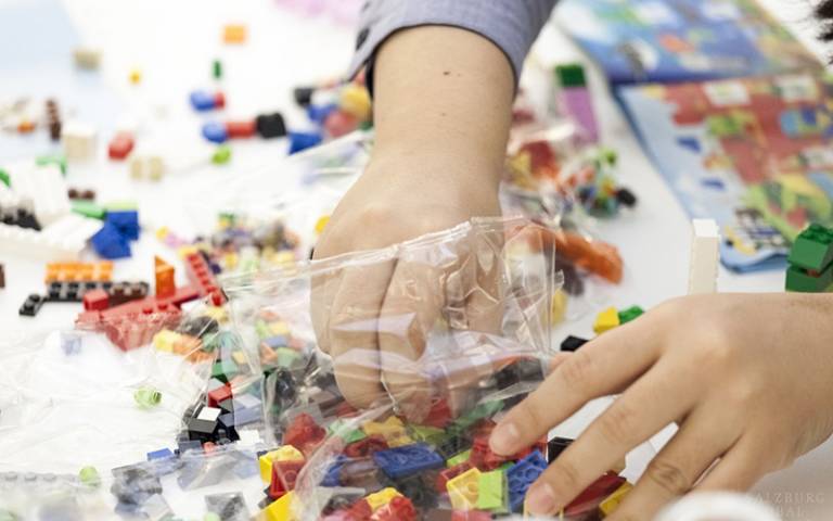 Lego bricks and hands