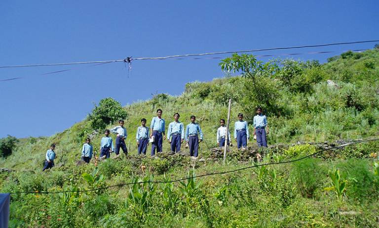 Male students standing on a hillside