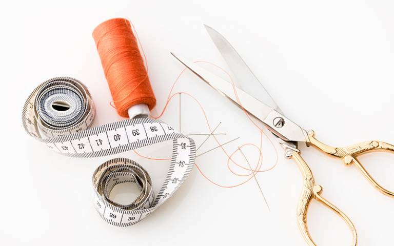 Measuring tape with thread and scissors