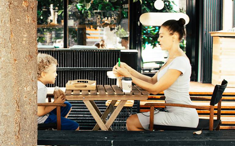 Parent and child eating at a cafe