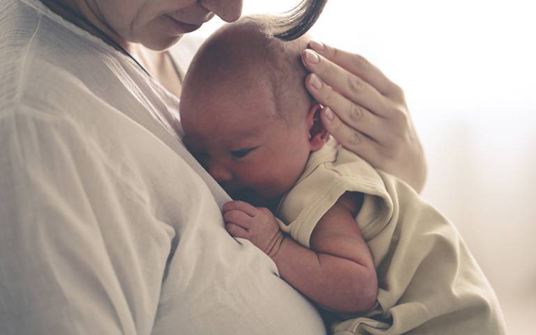 A newborn child being carried (Image: natialieb / Adobe Stock)