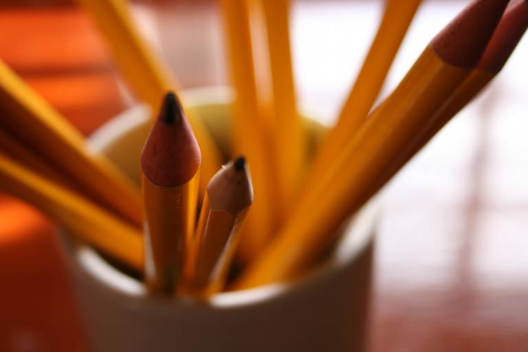 Cup of orange pencils