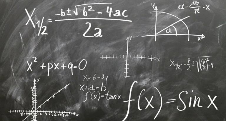 Maths equations written on a blackboard