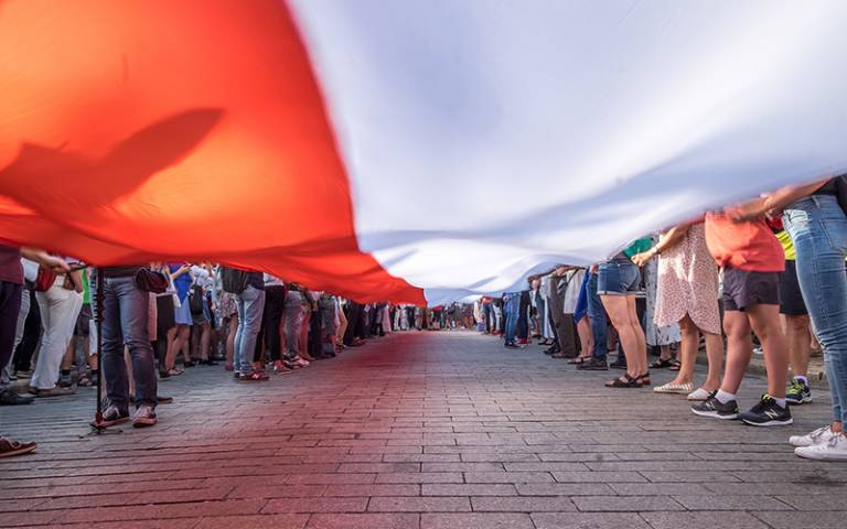 Polish flag being held by people at a celebration