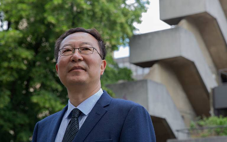 Professor Li Wei standing outside the IOE building