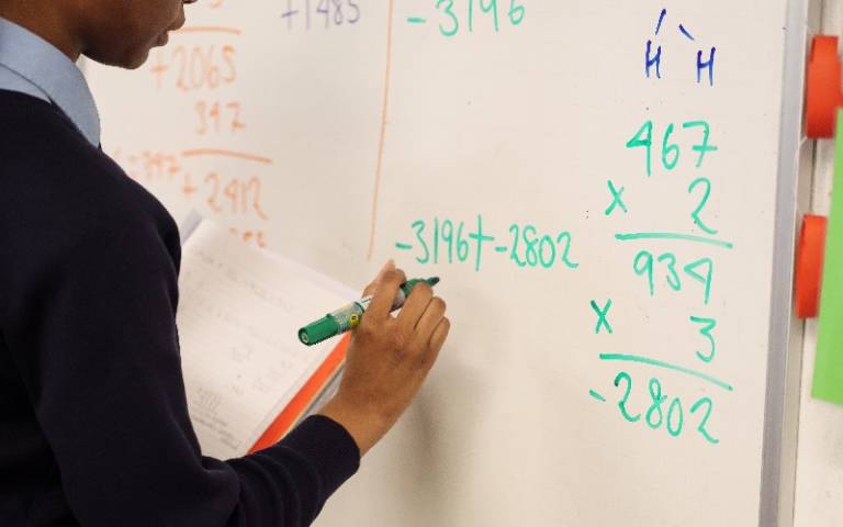Pupil doing sums on school whiteboard. Image: Phil Meech for UCL Institute of Education