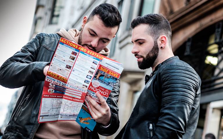 Two men reading a map aloud