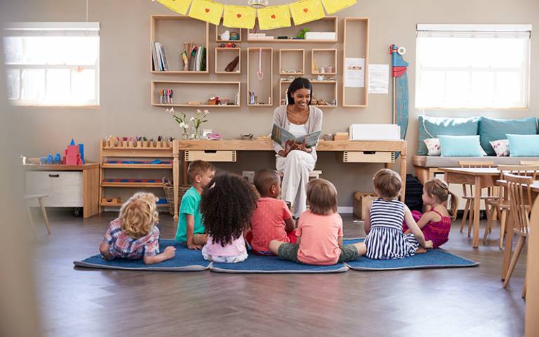 Teacher and children in an early years setting. Image: Monkey Business / Adobe Stock