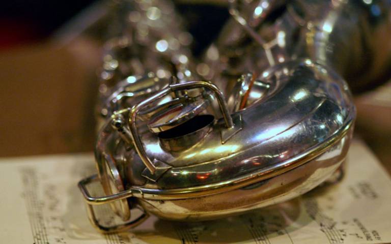 Saxophone resting on sheet music