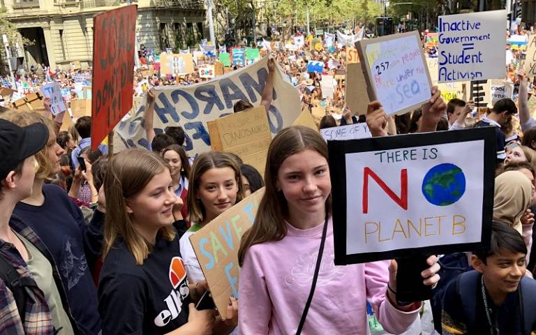 School pupils holding placards in school climate strike protest