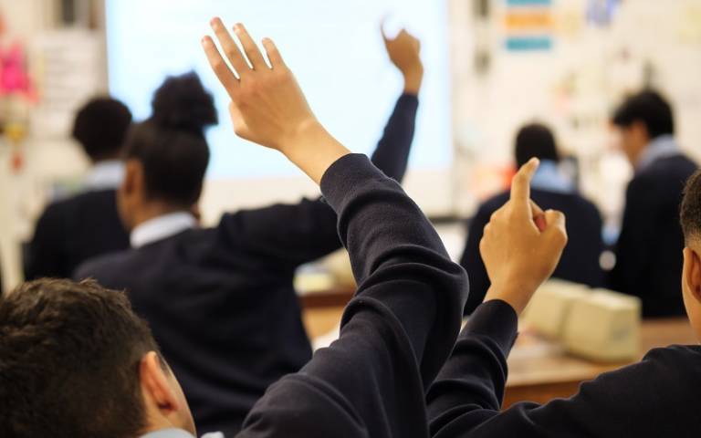 Secondary school pupils raising their hands in class. Image: Phil Meech for UCL Institute of Education