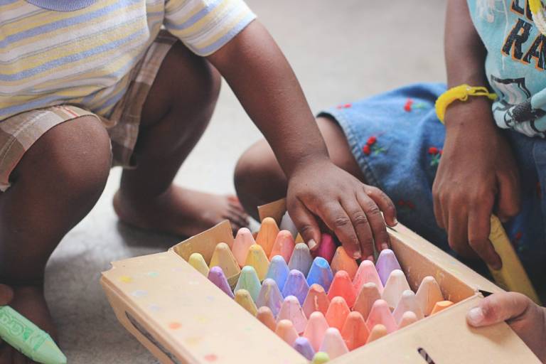Children choosing crayons from a box