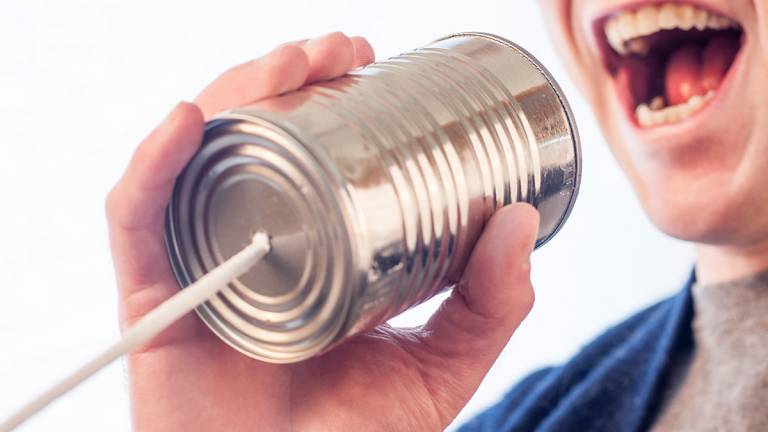 Speaking on a tin can and string telephone