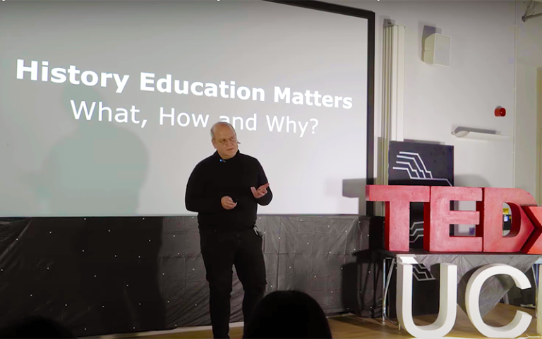 A photo of Arthur Chapman speaking about history education. Image credit: TEDx x UCL.