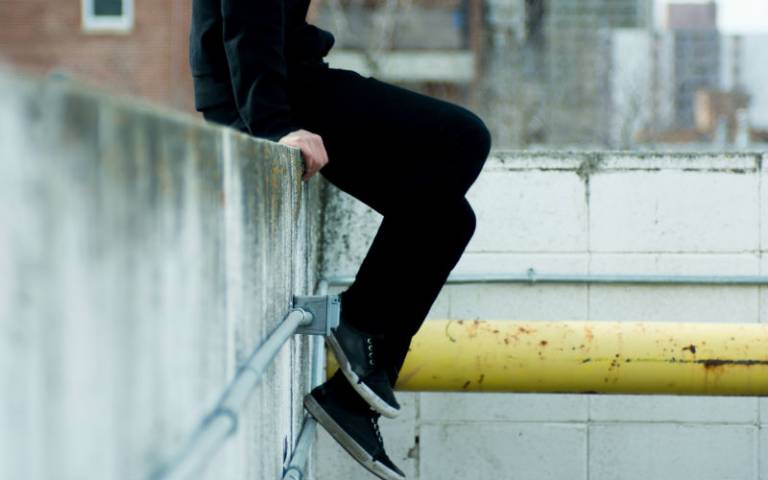 Teenager sat on wall