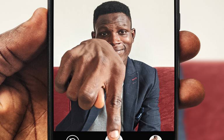 Man reaching through phone screen. Image by Oladimeji Ajegbile from Pexels