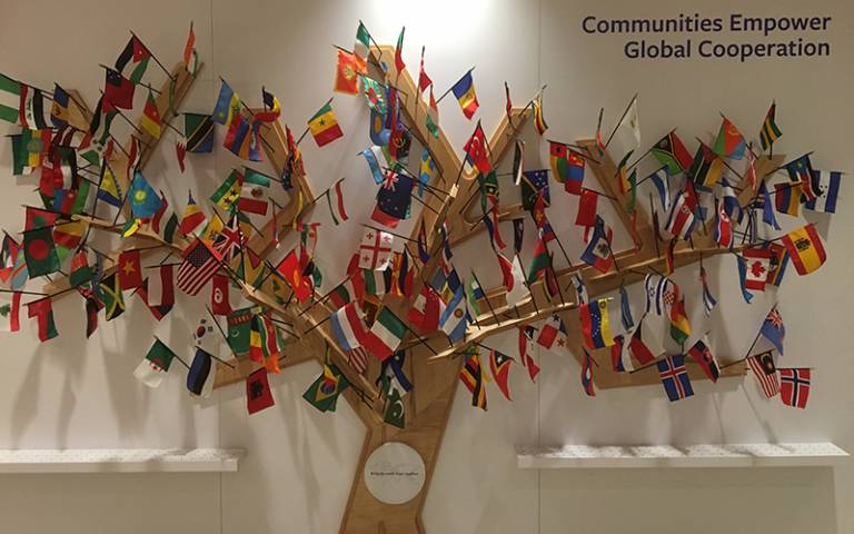 UN flags on a wooden tree. Image: Courtesy of Lynn Ang for the IOE’
