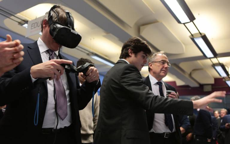 Universities minister wears a virtual reality headset during a visit to the IOE's EDUCATE programme