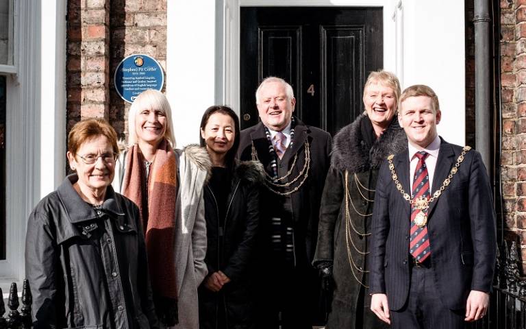 Group of people stood in front of Pit Corder blue plaque