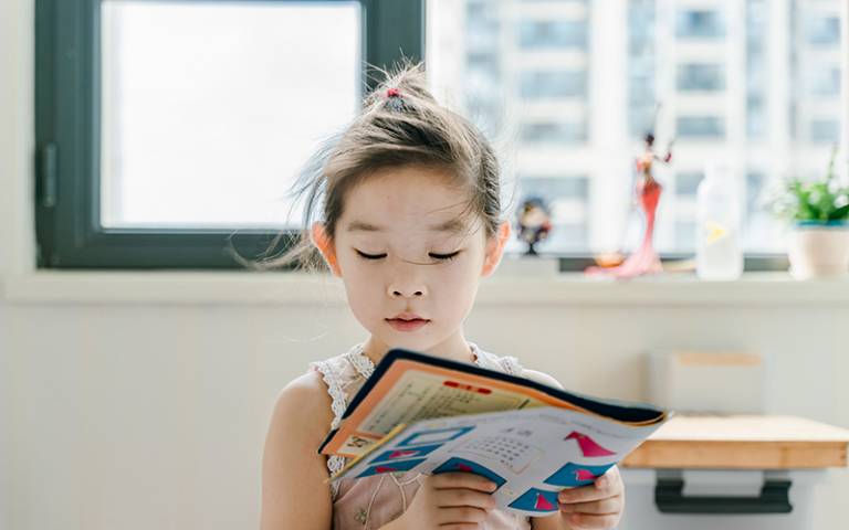 Girl reading book. Image: Jerry Wang via Unsplash