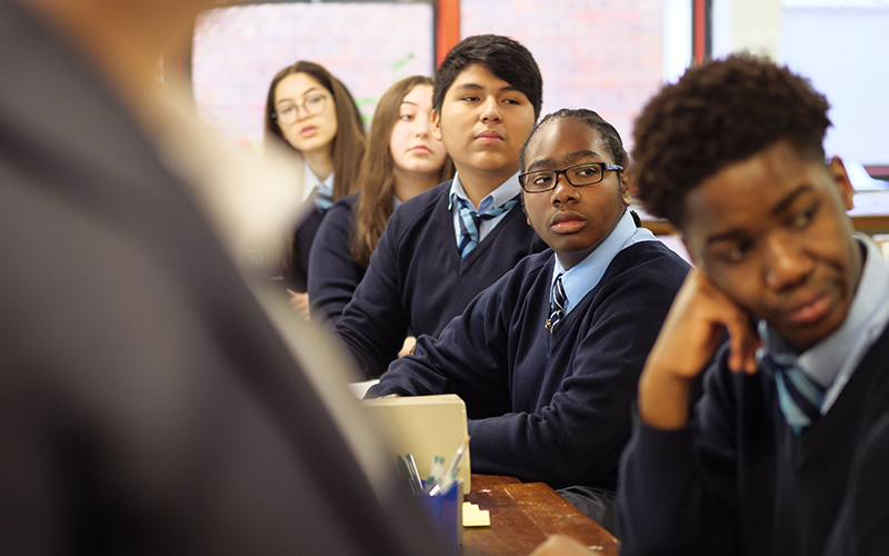 Secondary school pupils seated in a row. Image: Phil Meech for UCL Institute of Education