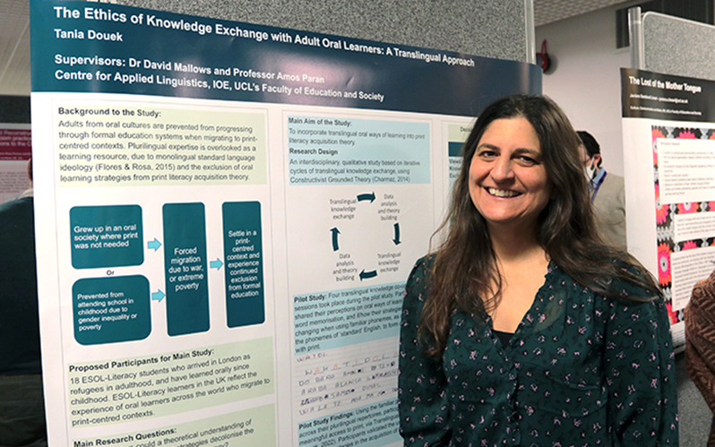 Doctoral student Tania smiles by her research poster. Credit: Gabrielle Fadullon, UCL IOE.