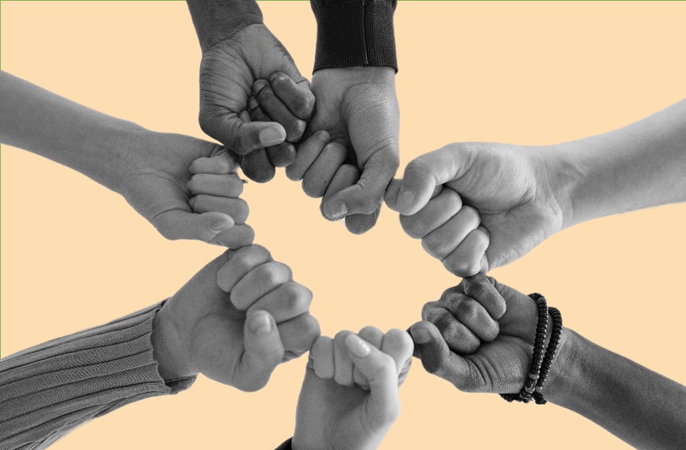 seven fists united forming a circle