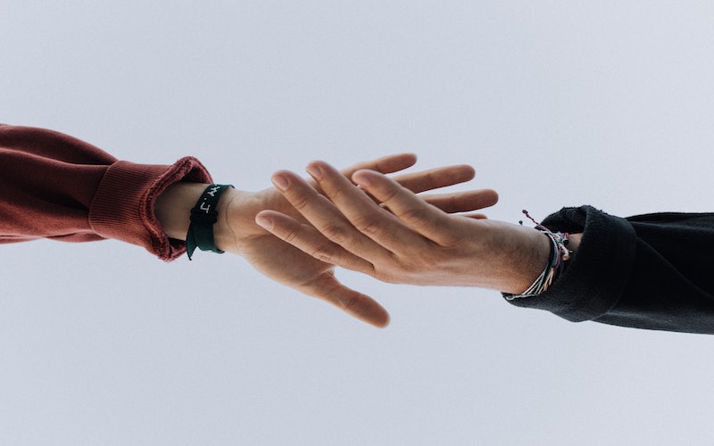 Image of two hands meeting